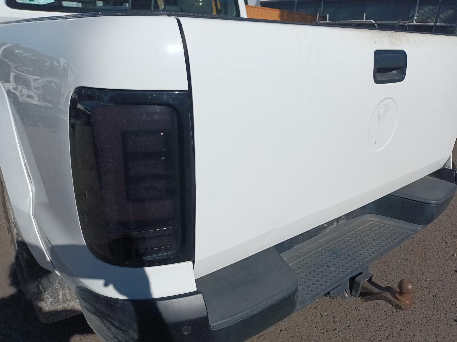 Rear Side of A White Pickup Truck with A Black Tail Light — South West 4WD Wreckers In Harristown, QLD