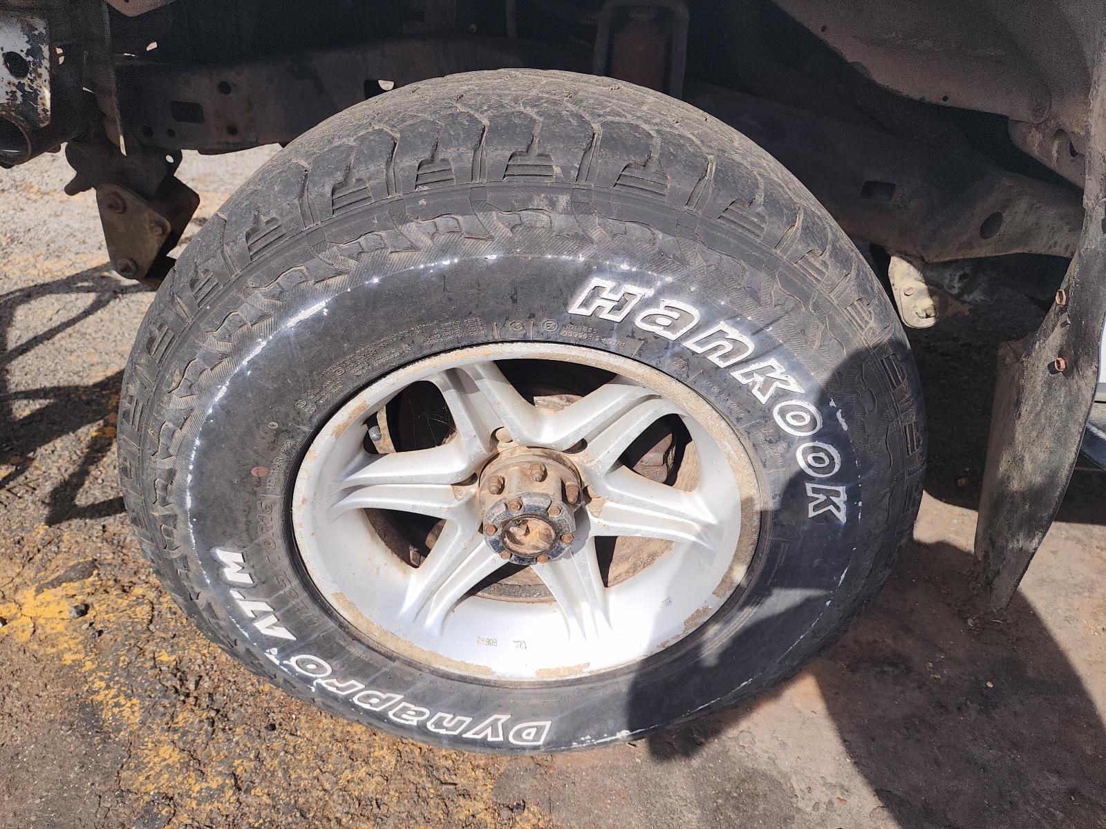 Flat Tyre on a White Rimmed Vehicle Wheel — South West 4WD Wreckers In Harristown, QLD