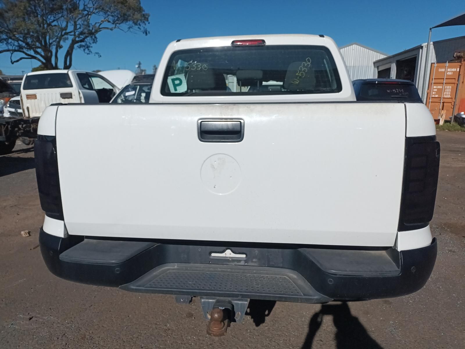 Rear View of A White Pickup Truck with A Tow Hitch Parked Outdoors — South West 4WD Wreckers In Harristown, QLD