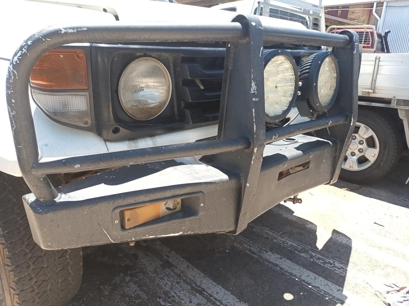 Front of A White Off-Road Vehicle with A Heavy-Duty Bull Bar — South West 4WD Wreckers In Harristown, QLD