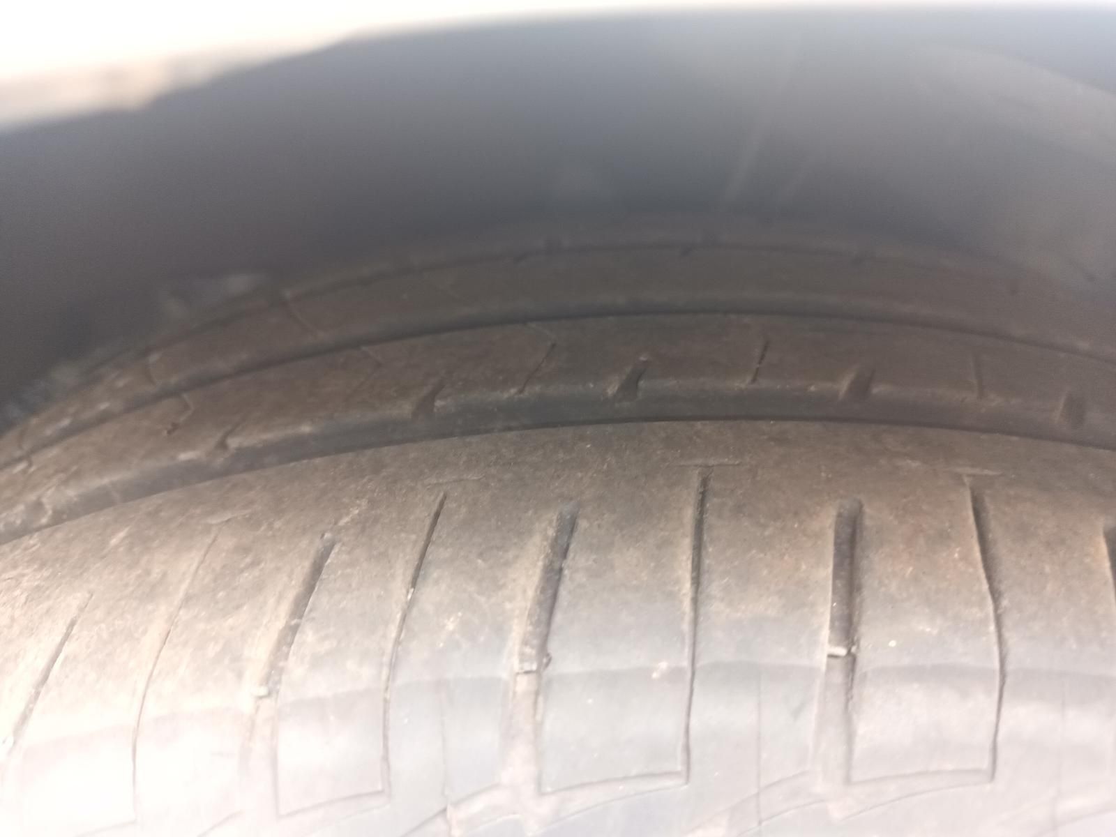 Close-Up of A Car Tyre Tread with Visible Wear and A Dark Wheel Well Above — South West 4WD Wreckers In Harristown, QLD