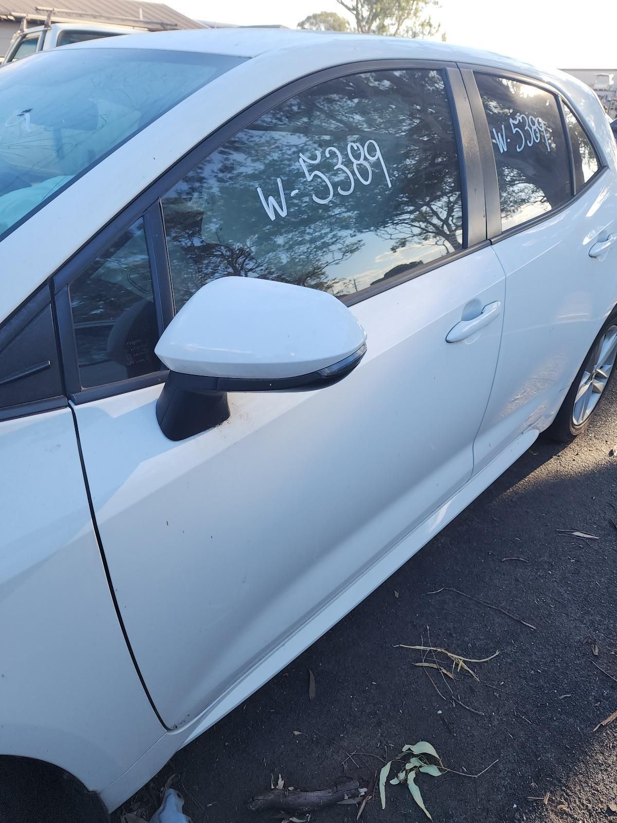 White Sedan Parked Outdoors, With “w 3699” Written — South West 4WD Wreckers In Harristown, QLD