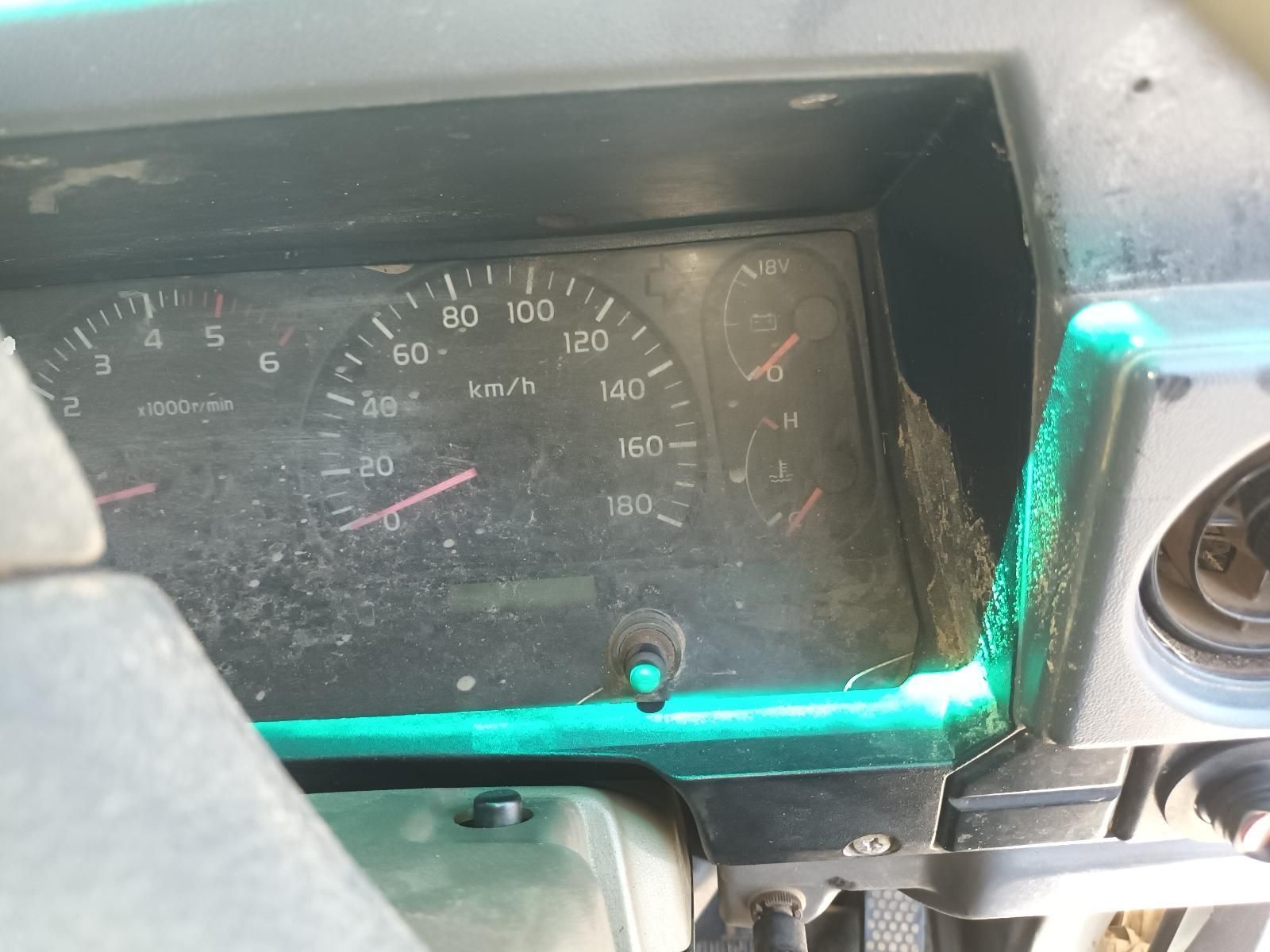 Close-Up of A Dusty Car Dashboard Speedometer with Red Needles and Green Trim — South West 4WD Wreckers In Harristown, QLD