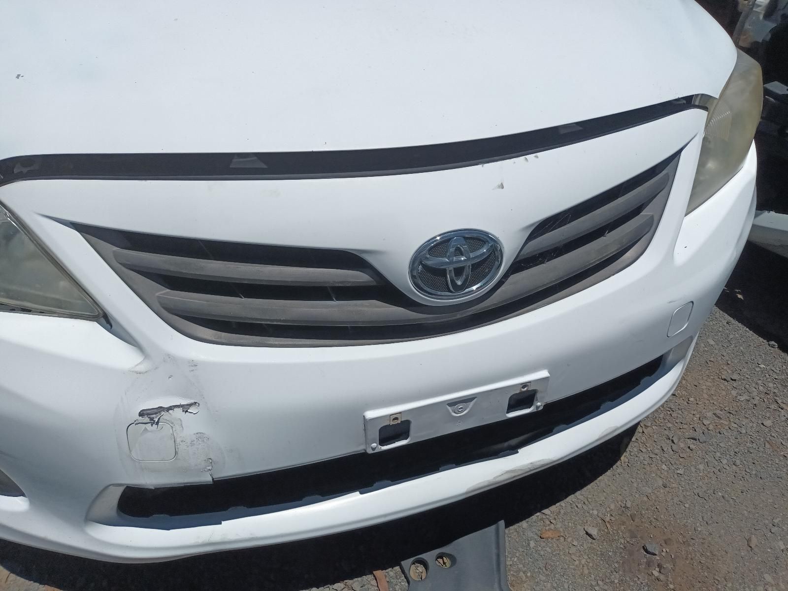 Front View of A White Toyota Car with A Damaged Front Bumper and Grille — South West 4WD Wreckers In Harristown, QLD