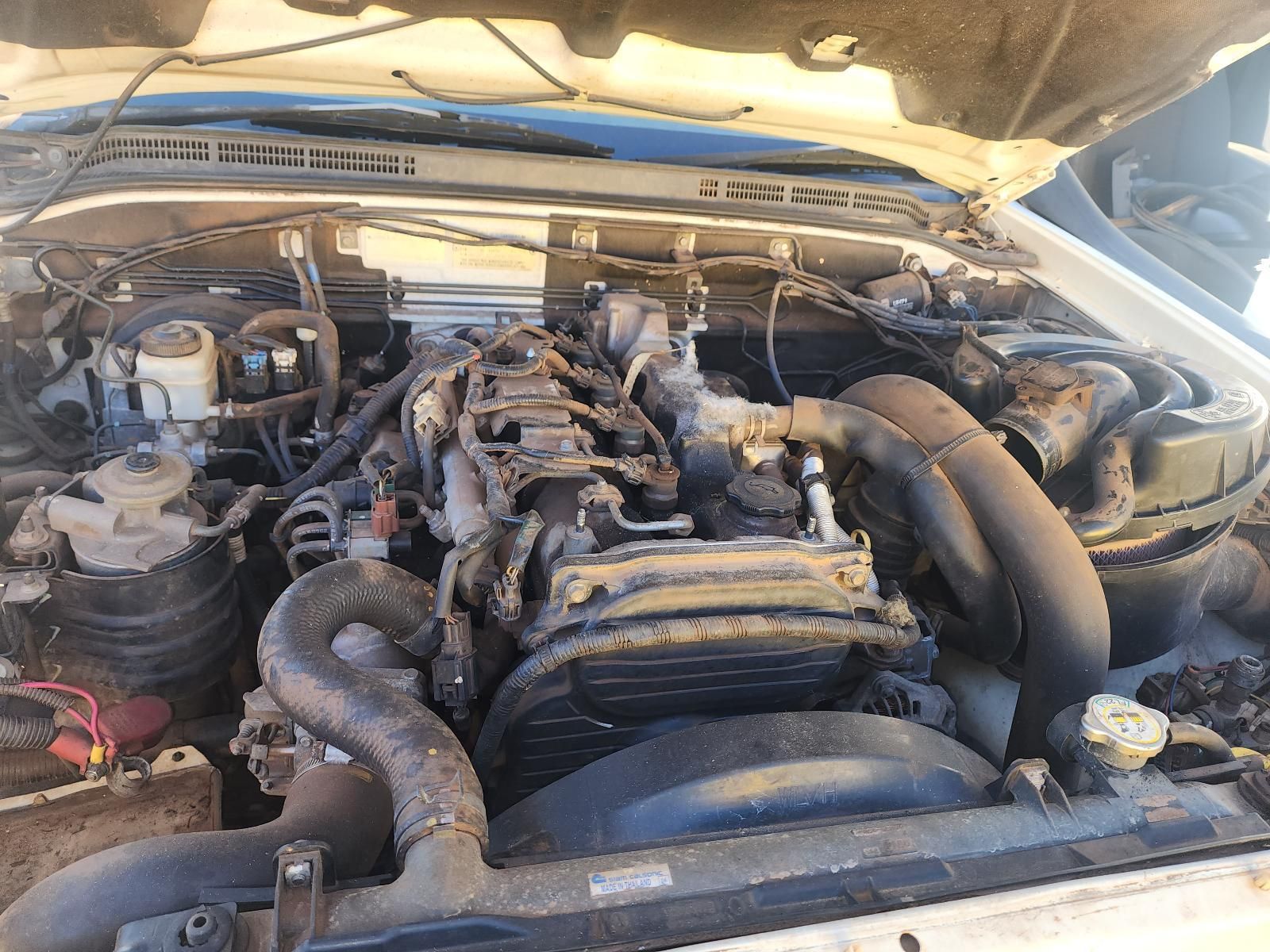 Dirty Car Engine Compartment Under an Open Hood — South West 4WD Wreckers In Harristown, QLD