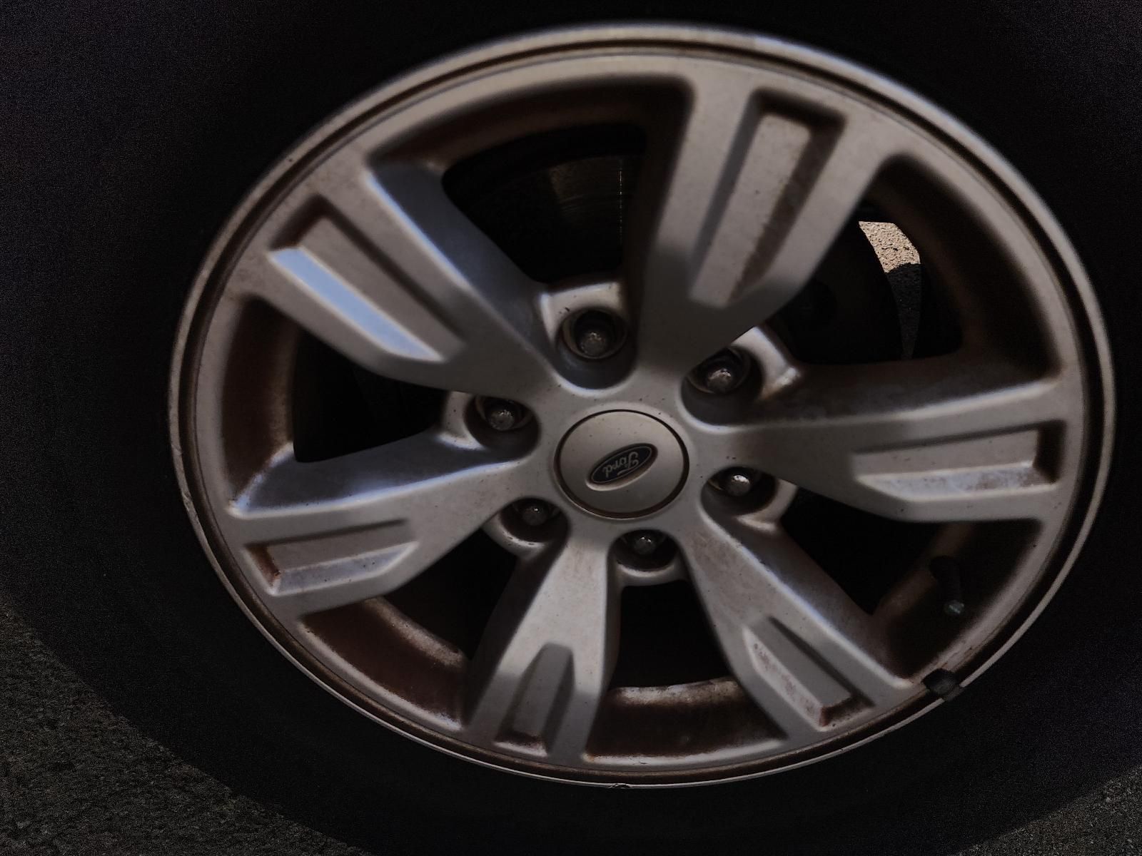 Close-up of a Silver Alloy Car Wheel Rim on a Dark Tyre — South West 4WD Wreckers In Harristown, QLD