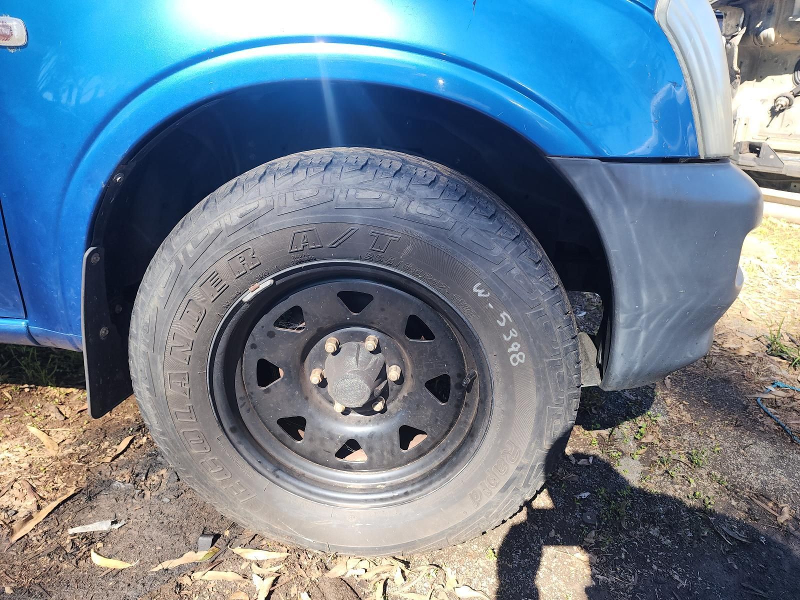 Close-up of a Blue Vehicle’s Front Wheel — South West 4WD Wreckers In Harristown, QLD