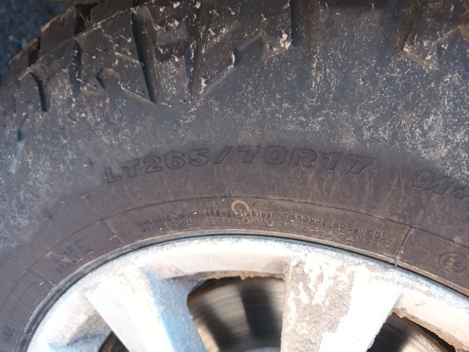 Close-Up of A Muddy Tyre and Silver Wheel Rim on A Vehicle — South West 4WD Wreckers In Harristown, QLD