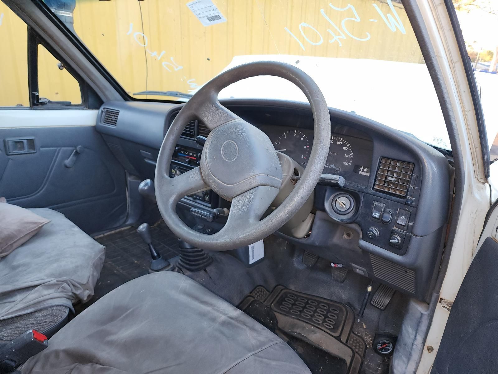 Old Car Interior With Gray Seats, Steering Wheel — South West 4WD Wreckers In Harristown, QLD