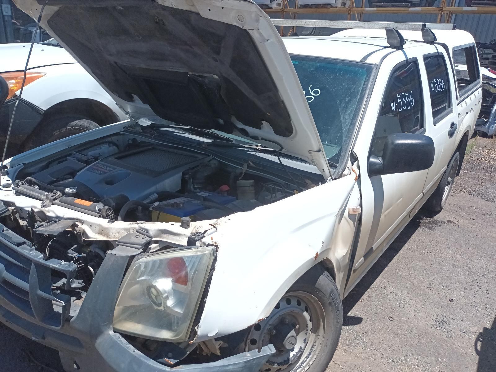 White Pickup Truck with Front-End Damage and Hood Open in A Parking Lot — South West 4WD Wreckers In Harristown, QLD