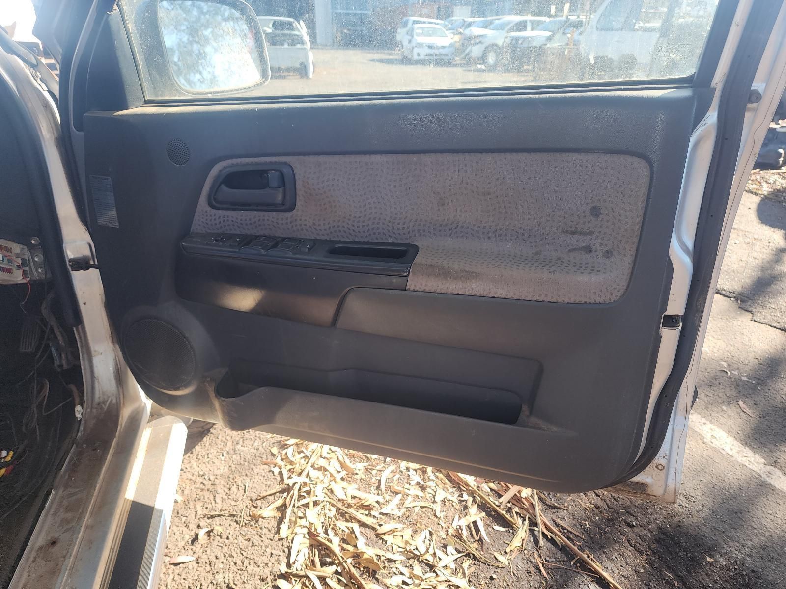 Open Car Rear Door with Grey Interior Panel and Speaker, Parked Outdoors on Dirt — South West 4WD Wreckers In Harristown, QLD