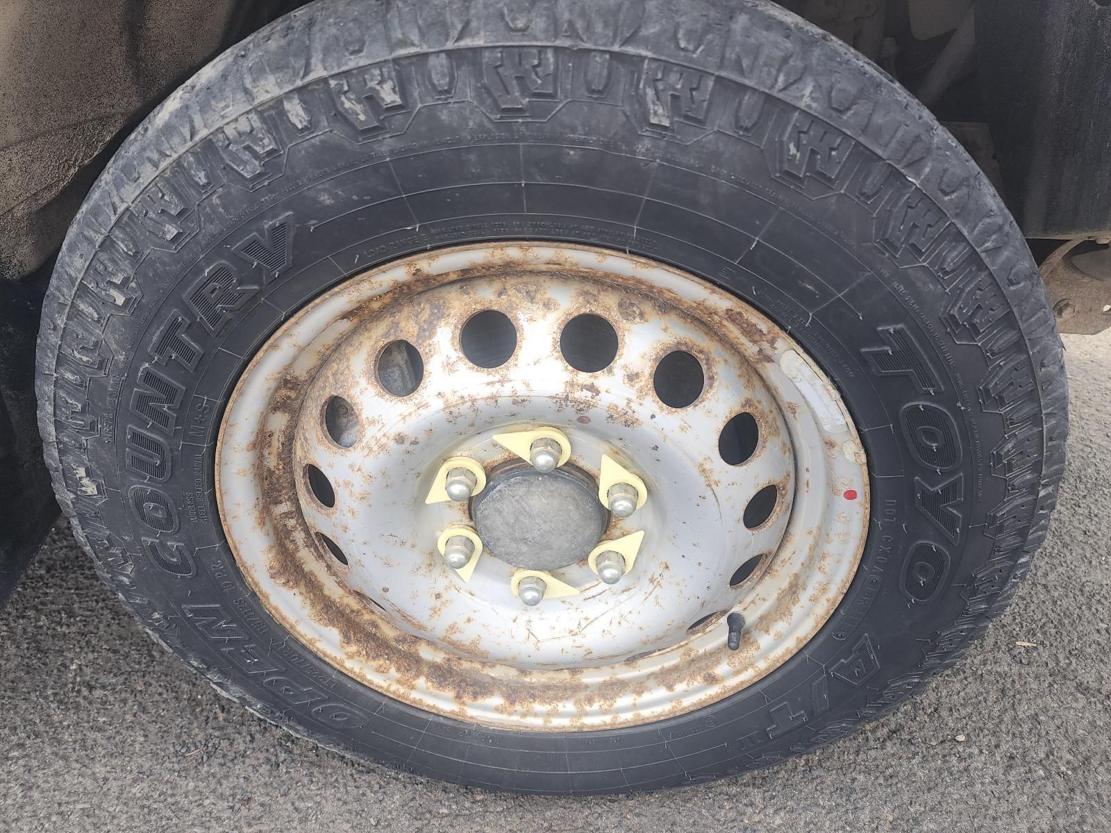 Rusty Truck Wheel With Tire and Silver Steel Rim — South West 4WD Wreckers In Harristown, QLD