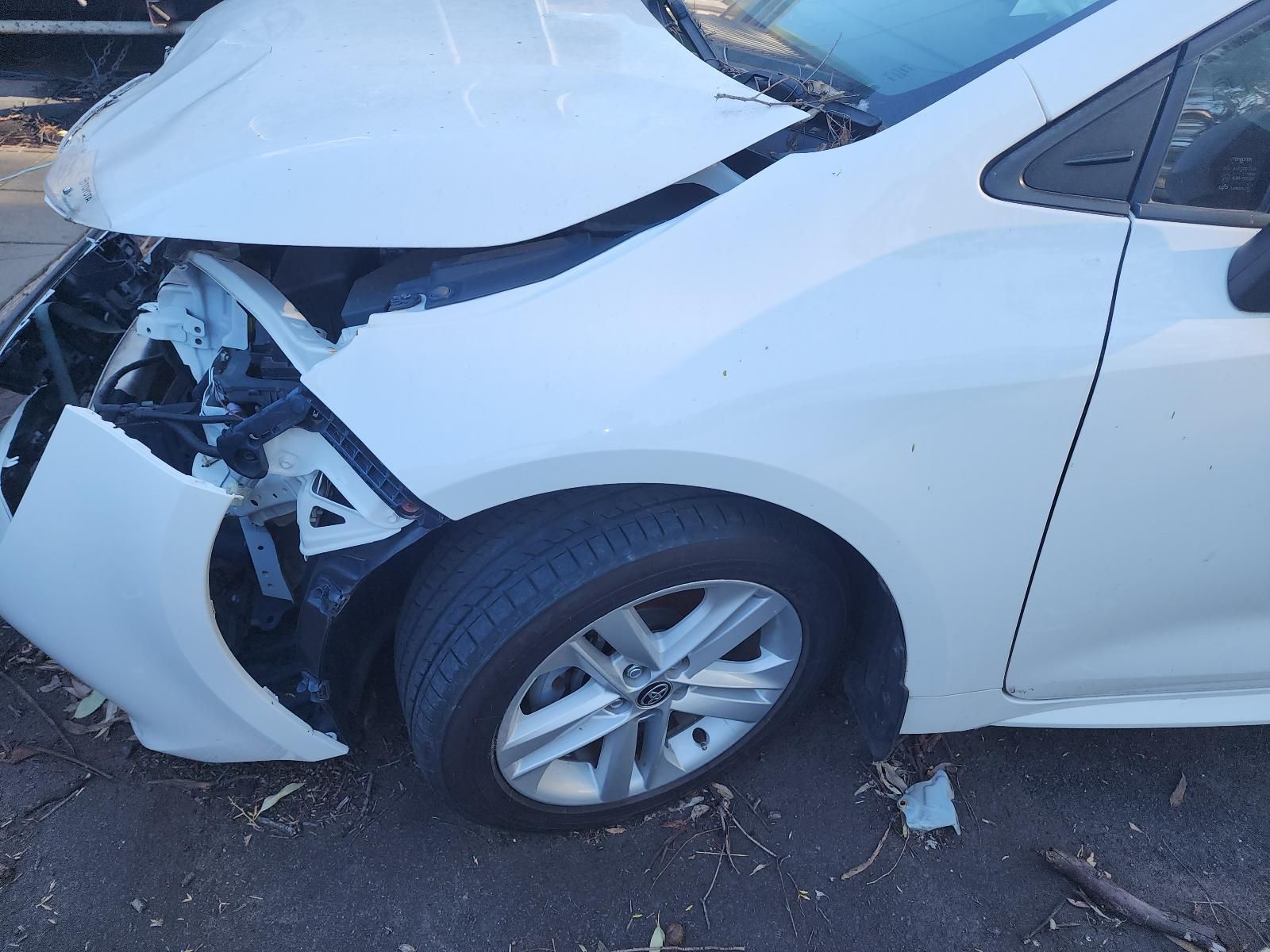 Front of a White Car Badly Damaged in a Collision — South West 4WD Wreckers In Harristown, QLD
