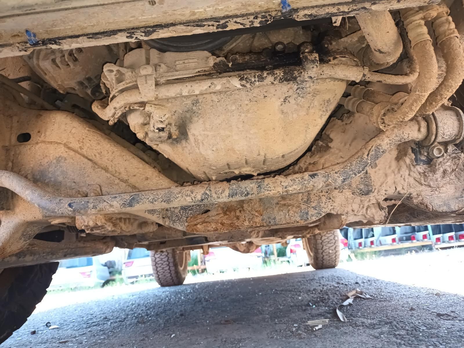 Undercarriage of A Muddy Vehicle, Showing the Exhaust and Suspension from Below — South West 4WD Wreckers In Harristown, QLD