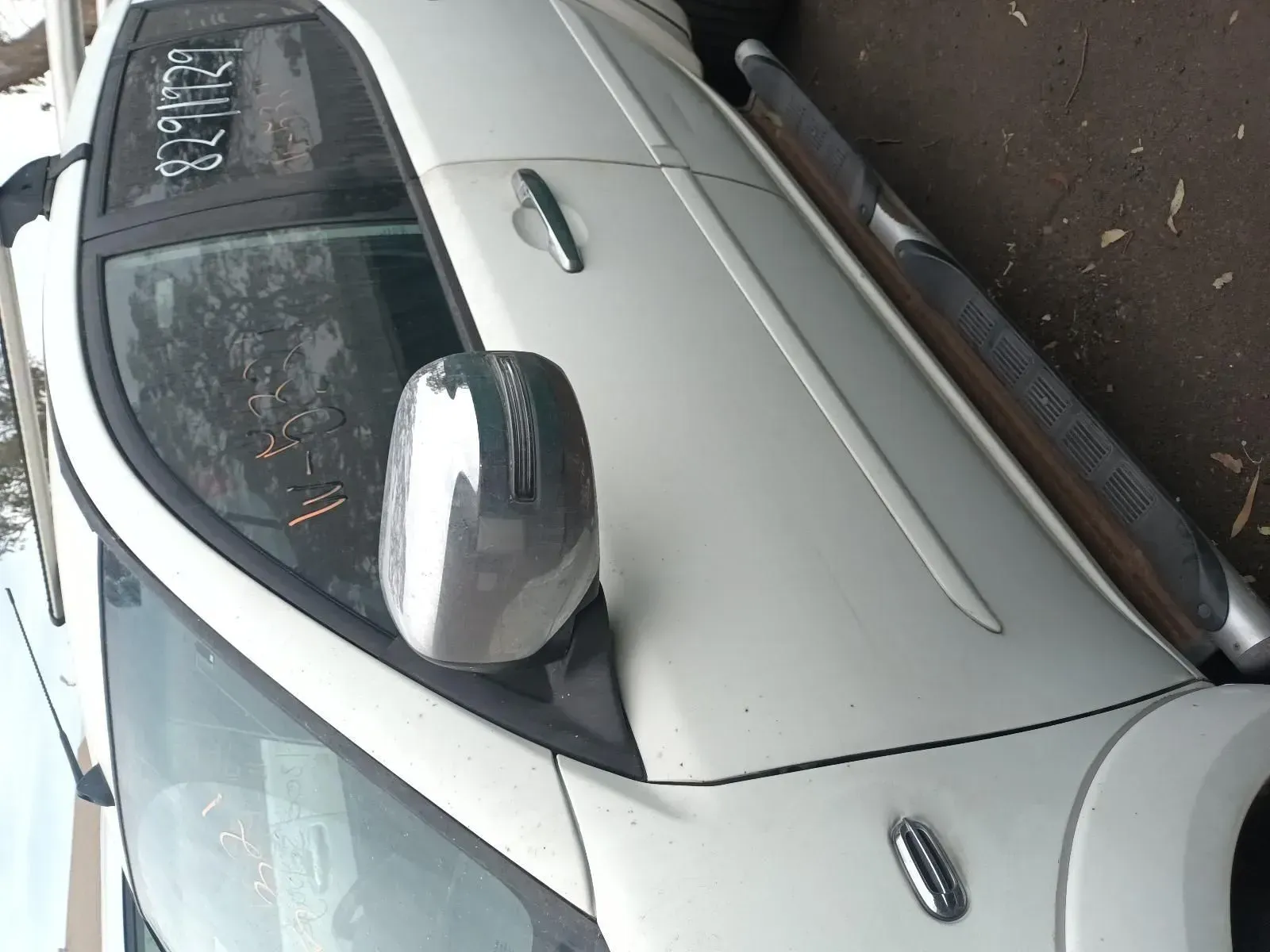 White Car's Side View, Showing Door, Mirror, and Running Board, Parked Outside — South West 4WD Wreckers In Harristown, QLD