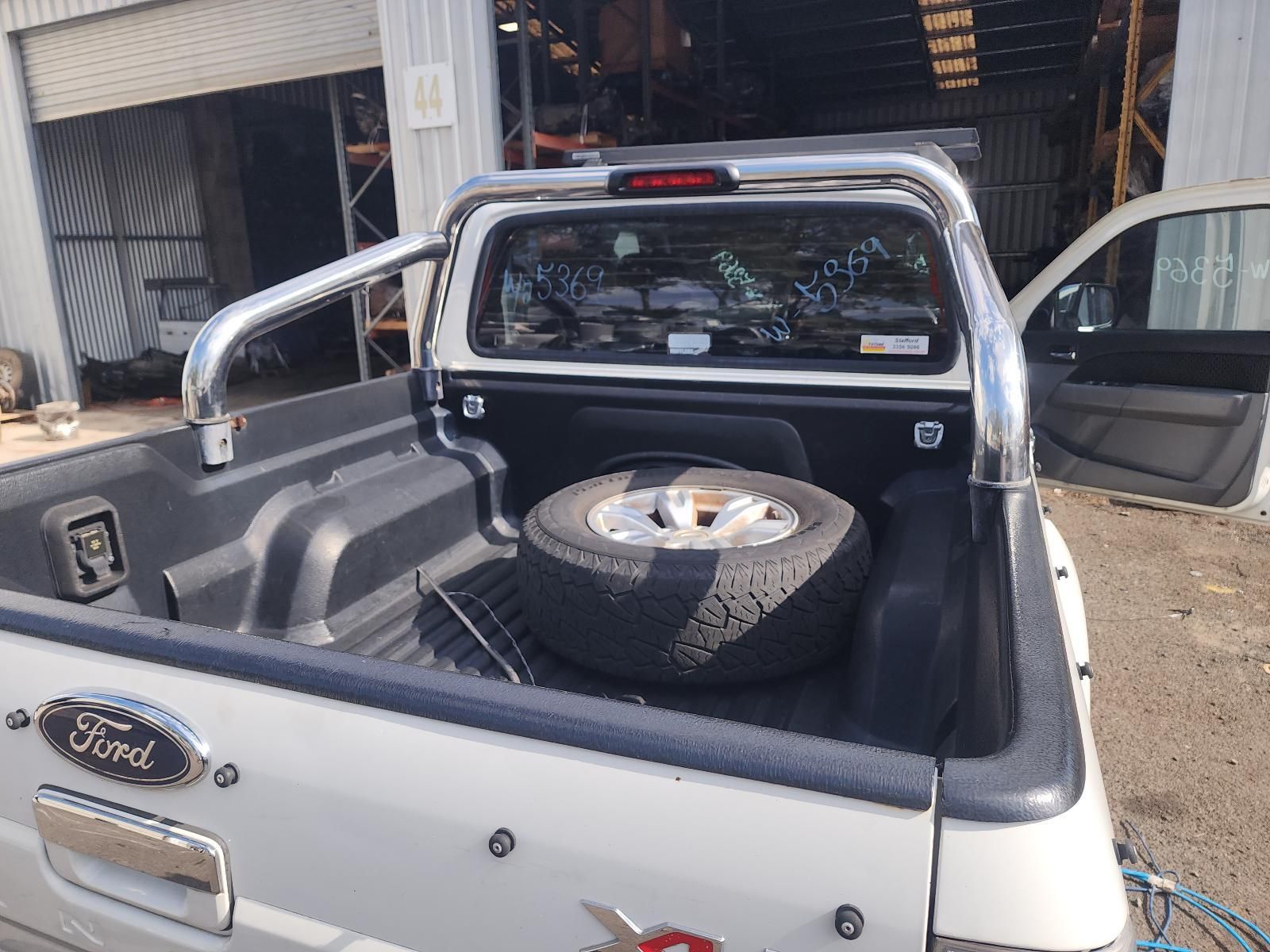 White Ford Pickup With Open Bed, Spare Tyre — South West 4WD Wreckers In Harristown, QLD