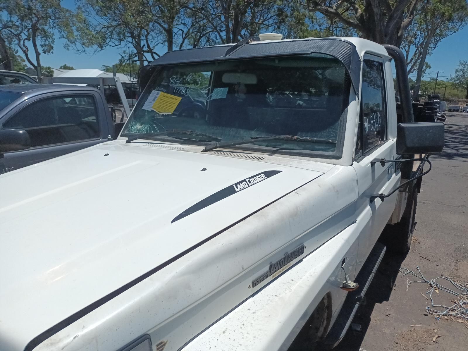 White Flatbed Truck Parked Outdoors in A Lot — South West 4WD Wreckers In Harristown, QLD