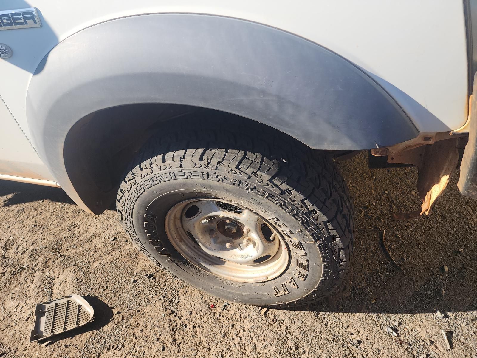 Front Wheel and Fender of a White Pickup Truck — South West 4WD Wreckers In Harristown, QLD