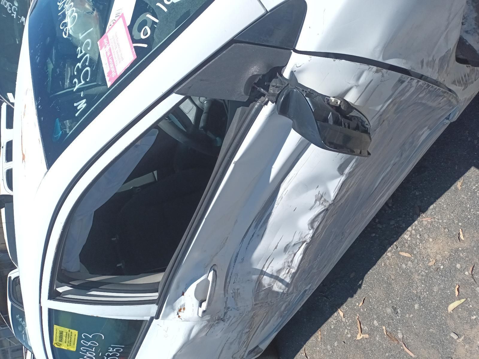 White Car with Severe Side Damage and A Crumpled Door After a Crash — South West 4WD Wreckers In Harristown, QLD