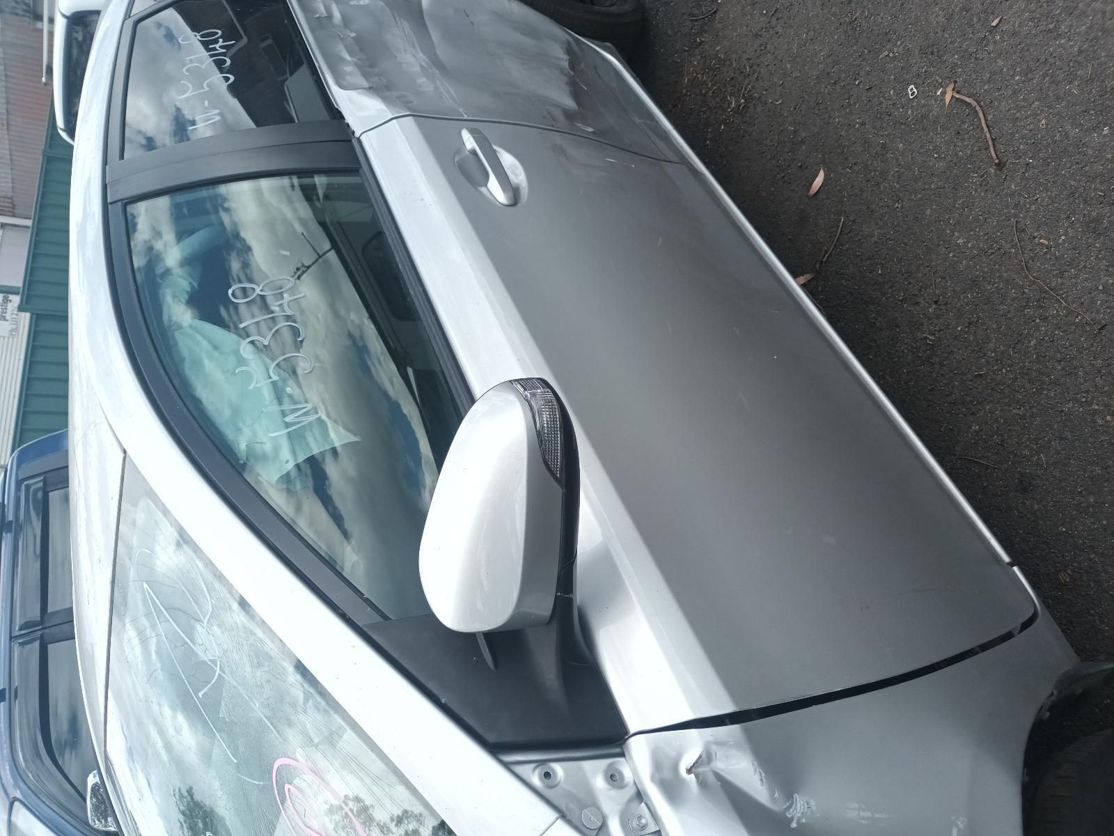Silver Car with A Cracked Windshield Parked on A Wet Street — South West 4WD Wreckers In Harristown, QLD