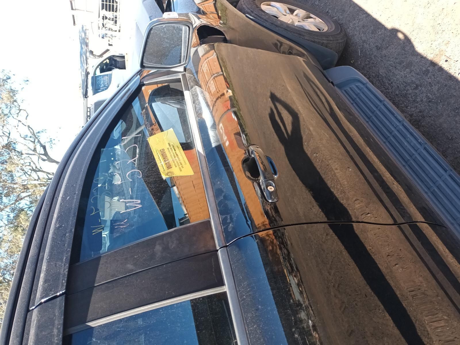 Side View of A Parked Black Car with A Yellow Notice — South West 4WD Wreckers In Harristown, QLD