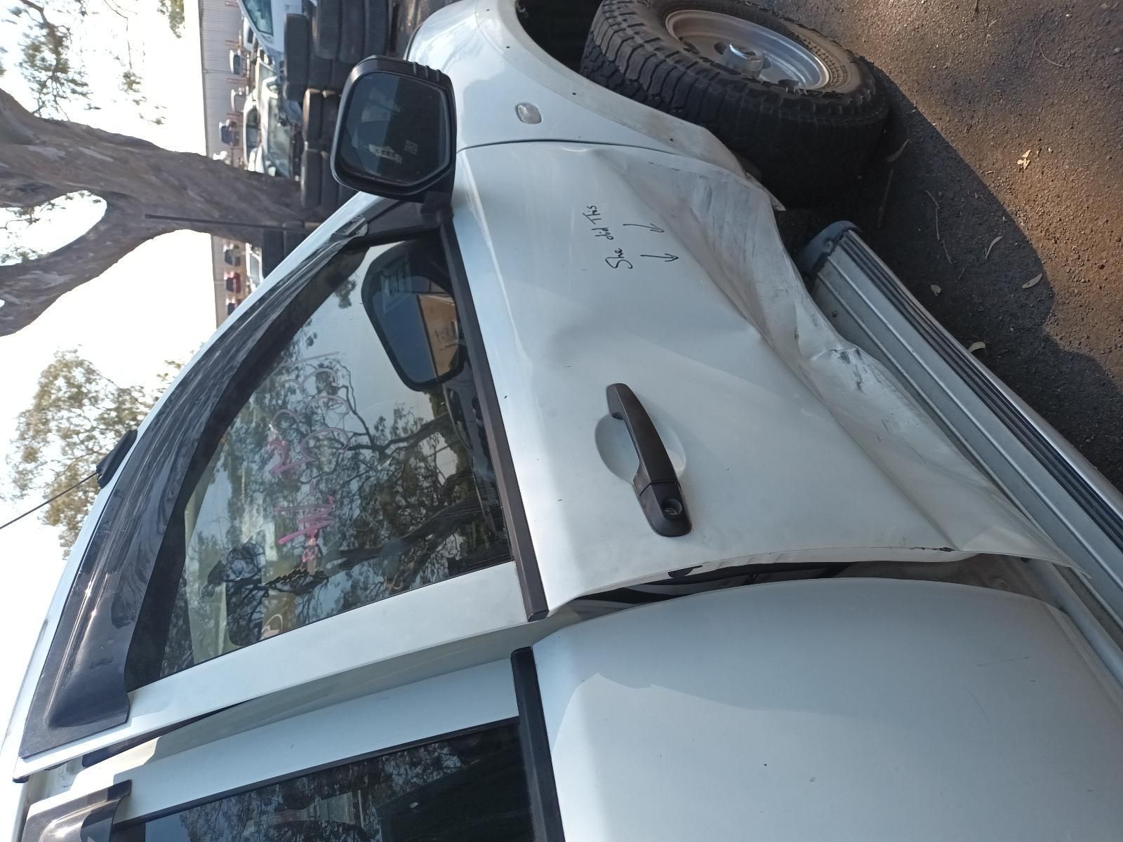 White Car Parked Beside a Tree on A Dirt Road — South West 4WD Wreckers In Harristown, QLD