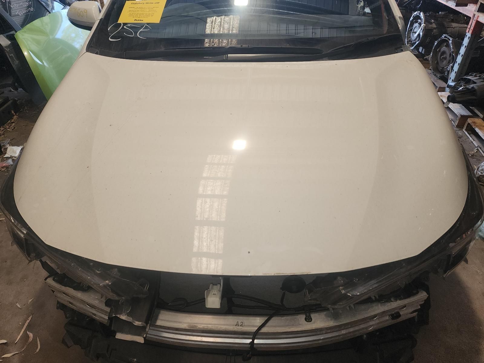 Damaged White Car Hood With Front Bumper Removed — South West 4WD Wreckers In Harristown, QLD