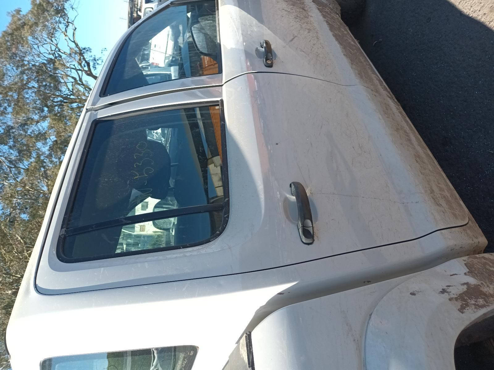 White Pickup Truck Parked Outdoors, Viewed from The Side in Bright Sunlight — South West 4WD Wreckers In Harristown, QLD