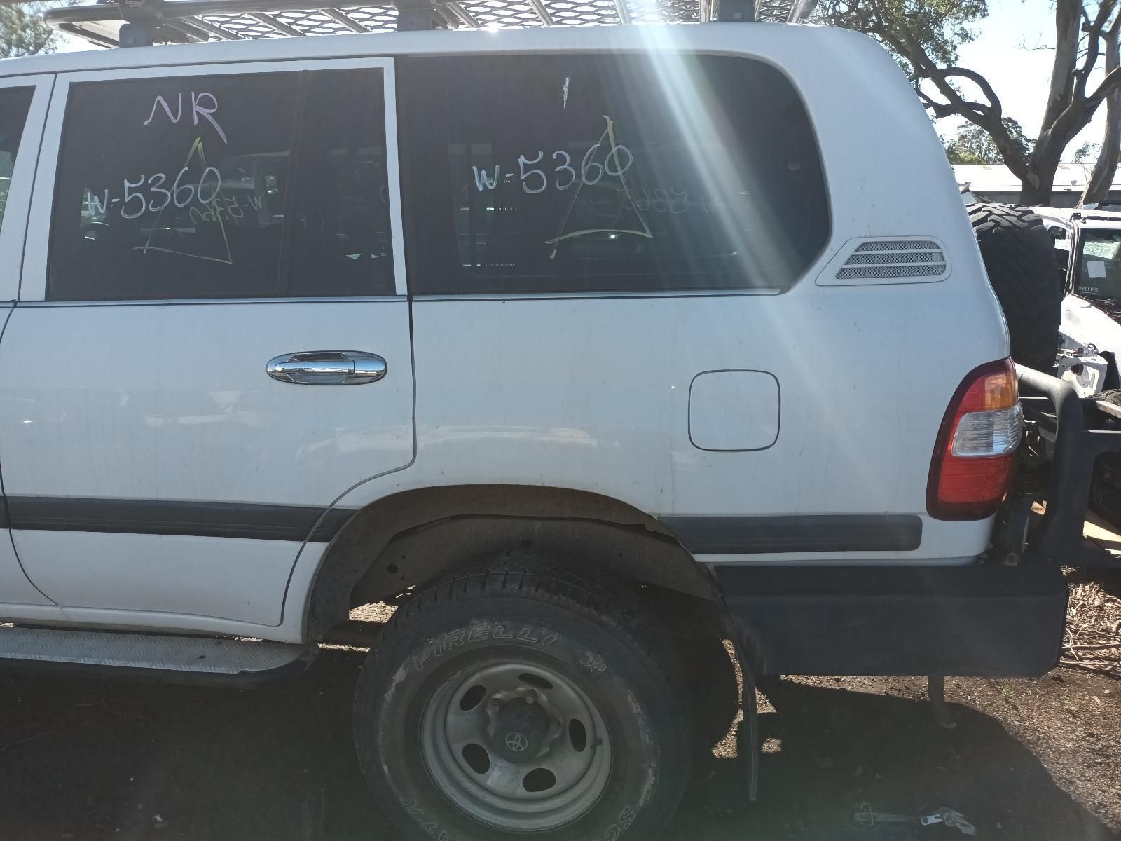 White Suv with Writing on The Windows, Parked Outdoors in A Dirt Lot — South West 4WD Wreckers In Harristown, QLD