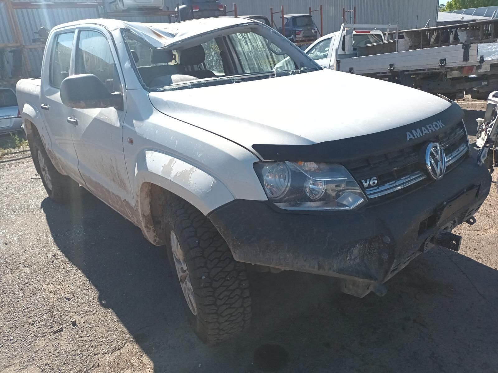 Damaged White Toyota Pickup Truck Parked Outdoors in Bright Sunlight — South West 4WD Wreckers In Harristown, QLD