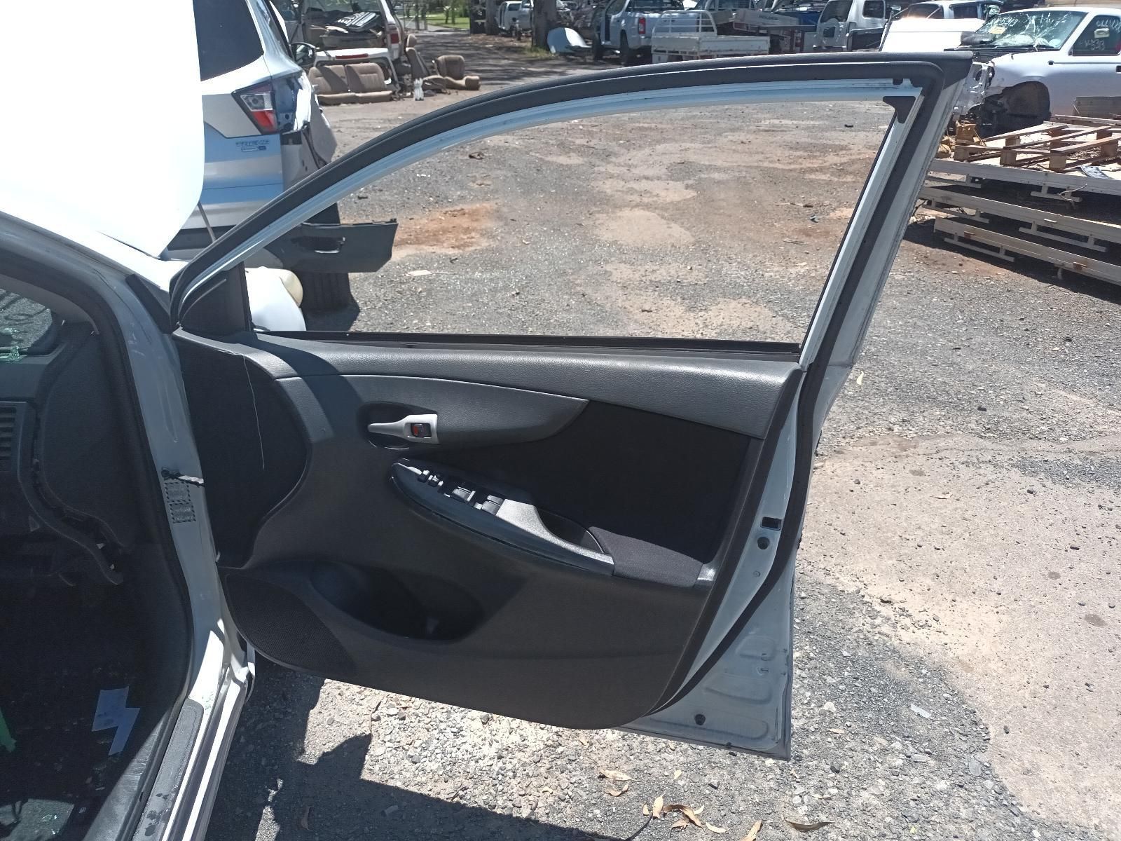 Open Car Door with Dark Interior Parked on A Gravel Lot — South West 4WD Wreckers In Harristown, QLD