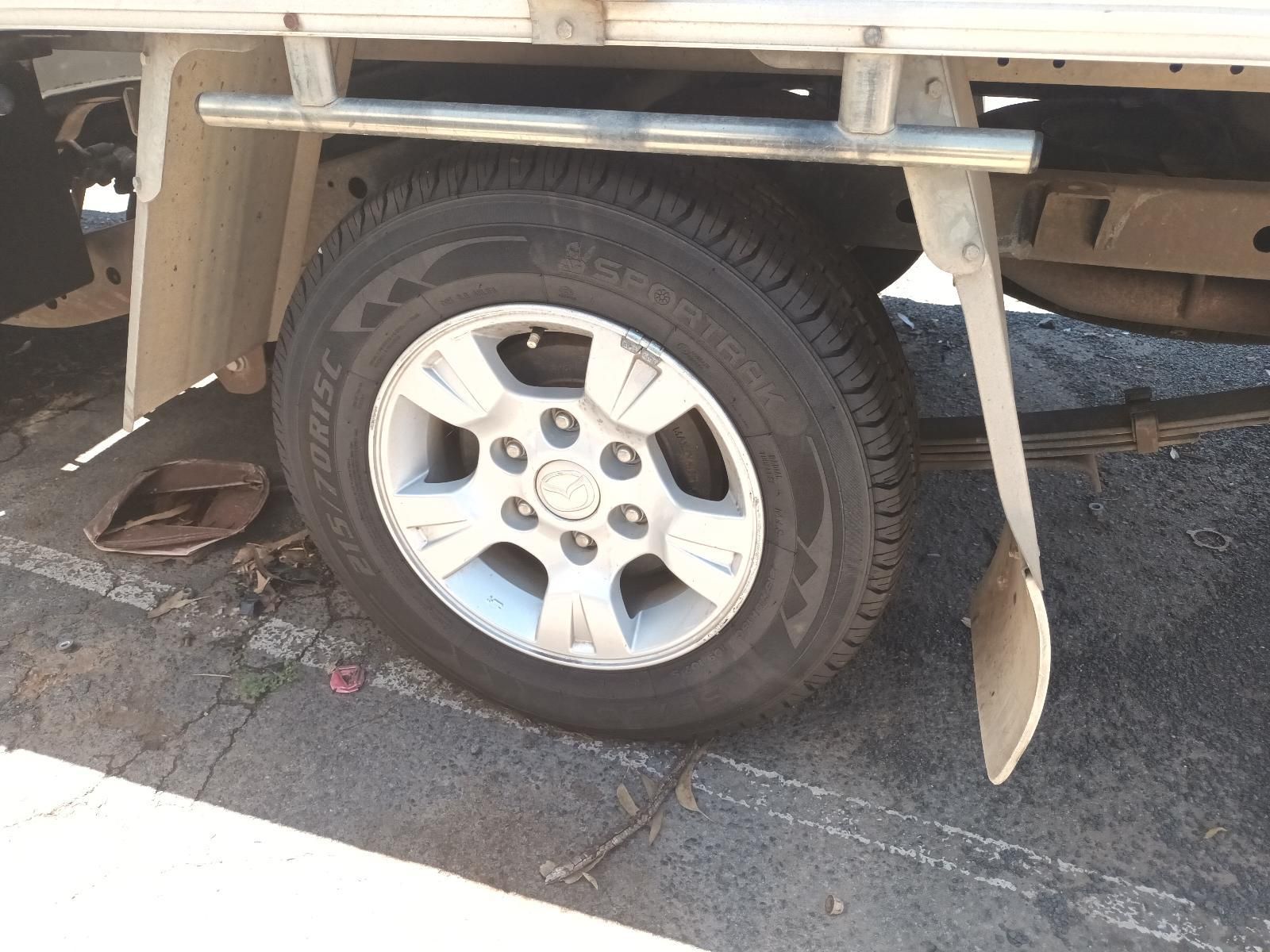 Close-Up of A Truck Tyre Beside a Damaged Curb — South West 4WD Wreckers In Harristown, QLD