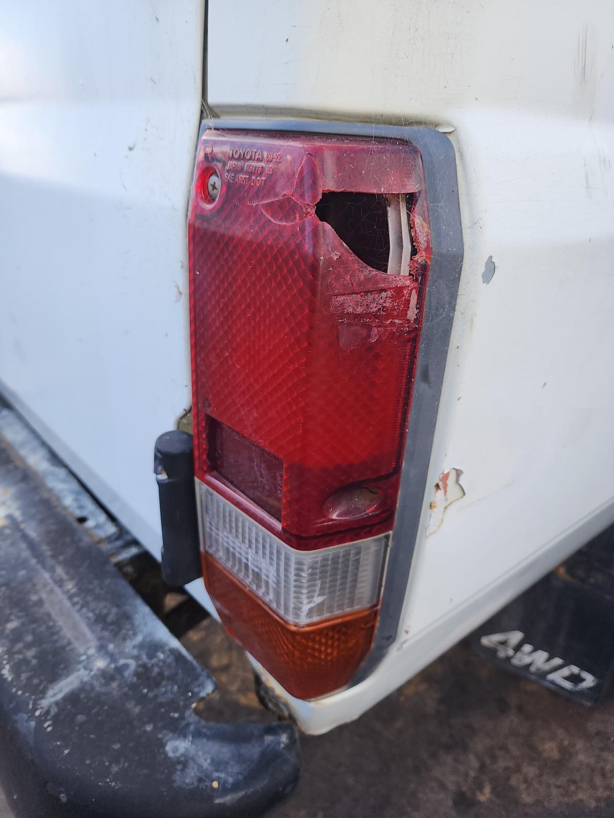 Damaged Red and White Pickup Truck Taillight — South West 4WD Wreckers In Harristown, QLD