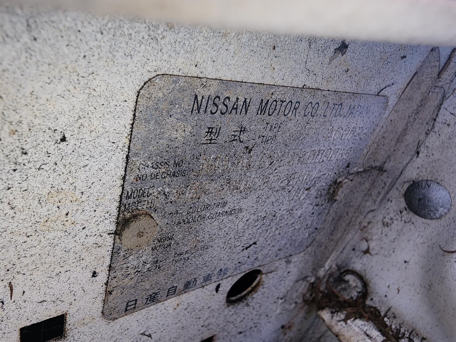 Close-up of a Dusty Metal Nissan Identification Plate — South West 4WD Wreckers In Harristown, QLD