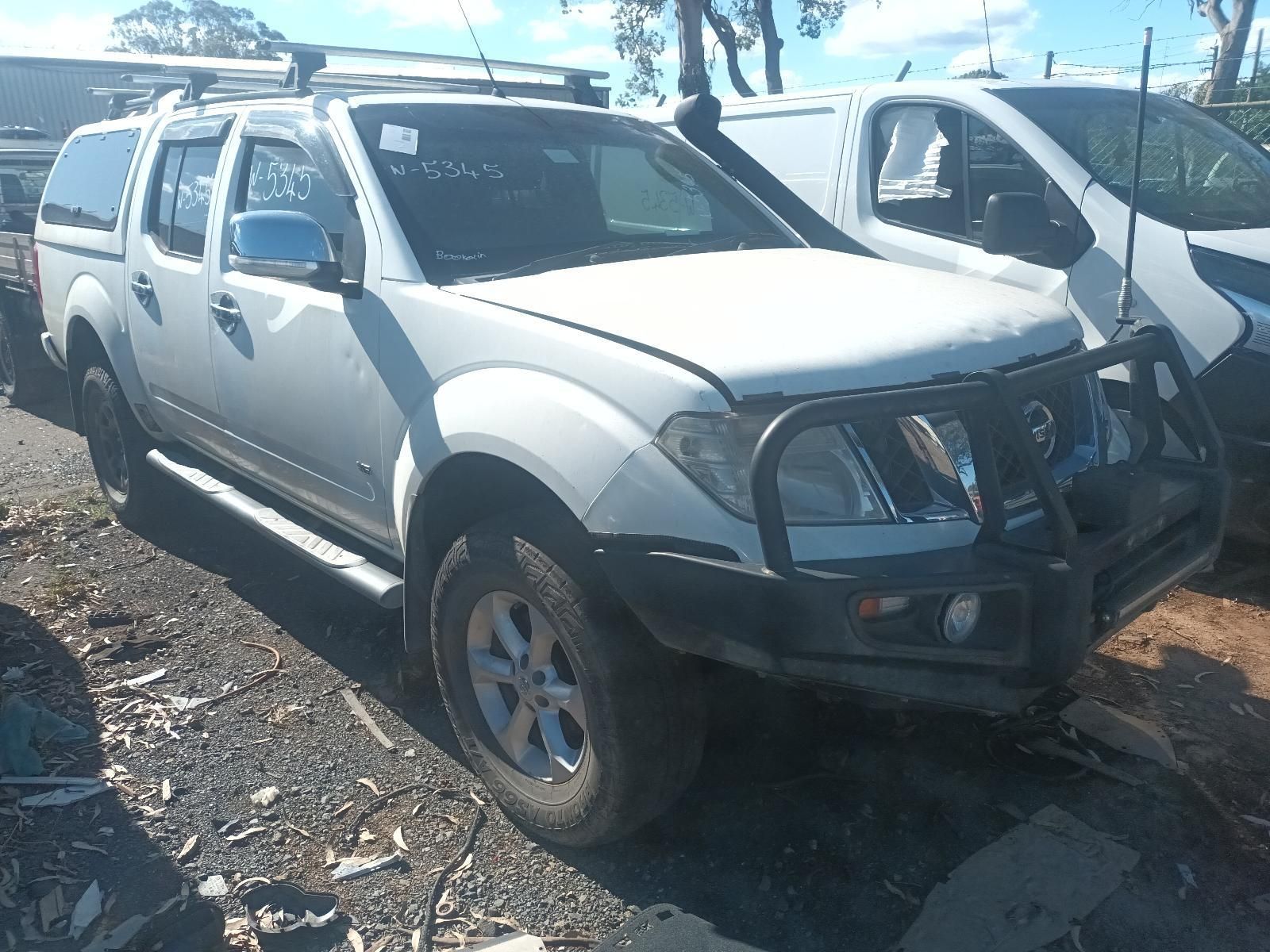 White Suv with A Bull Bar Parked on Rocky Ground at A Salvage Yard — South West 4WD Wreckers In Harristown, QLD