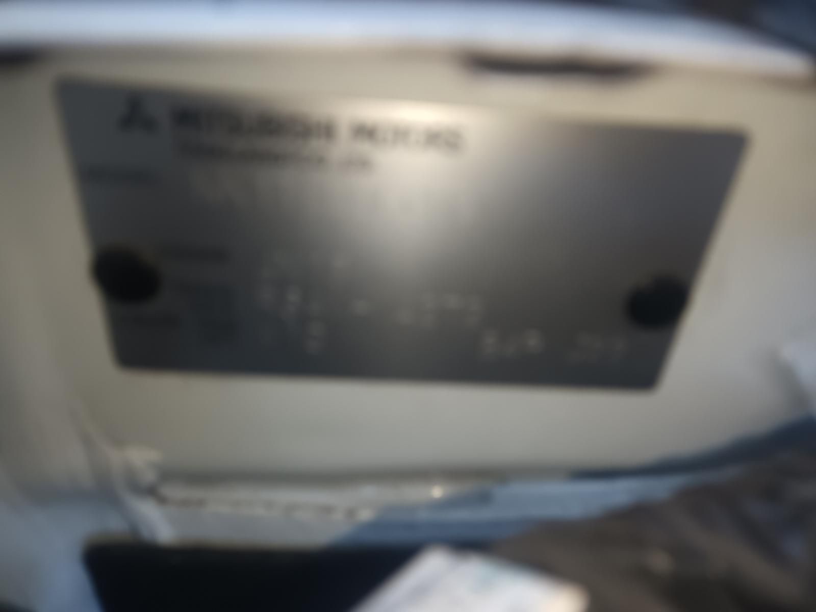 Blurred Close-Up of A Wall-Mounted Metal Equipment Label — South West 4WD Wreckers In Harristown, QLD