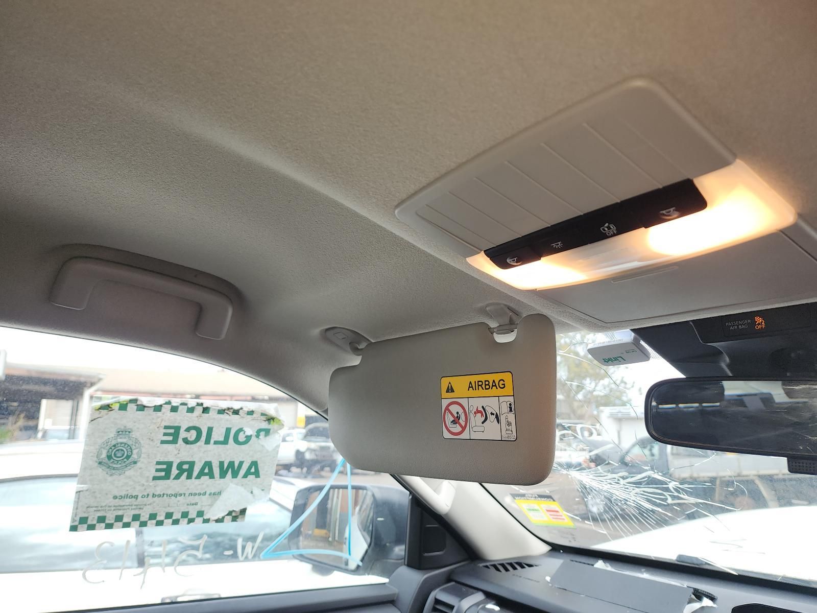 Inside a Car, a Rearview Mirror Hangs Below the Ceiling Light — South West 4WD Wreckers In Harristown, QLD