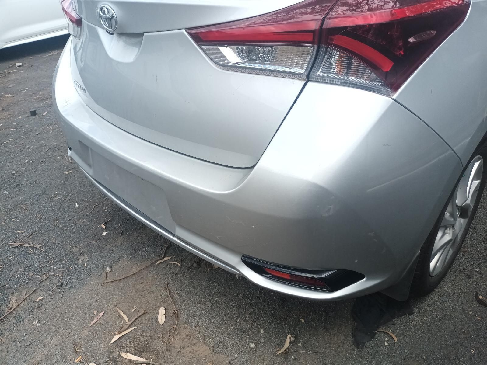 Rear View of A Silver Sedan with Minor Bumper Damage, Parked on A Wet Street — South West 4WD Wreckers In Harristown, QLD