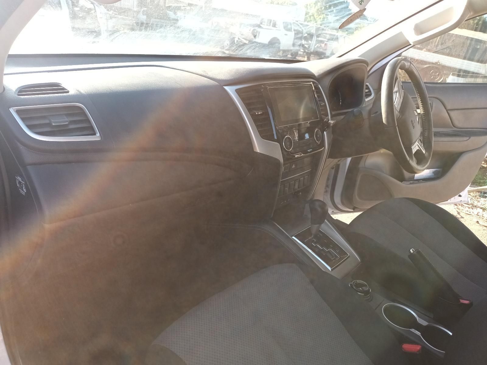Car Interior with Black Seats, Dashboard, Steering Wheel, and Sunlight Streaming — South West 4WD Wreckers In Harristown, QLD