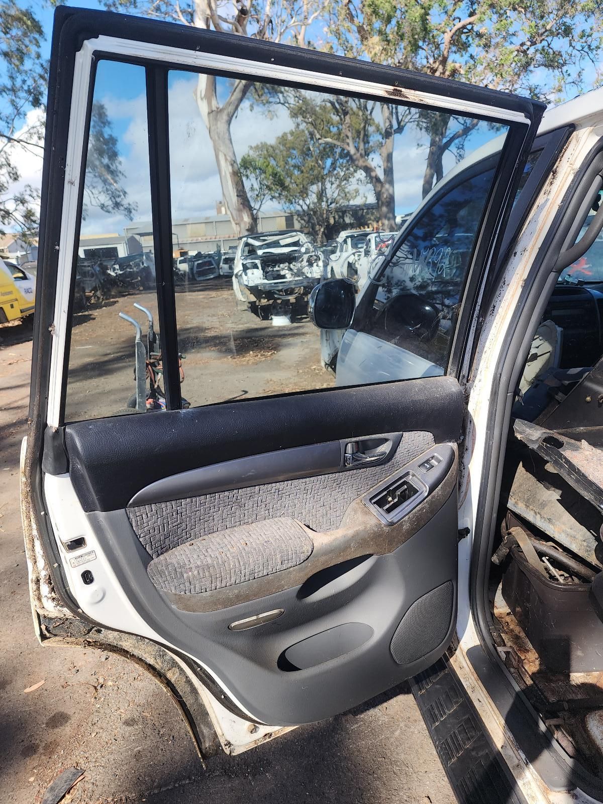 Open Car Door With Cracked Window and Gray Interior — South West 4WD Wreckers In Harristown, QLD