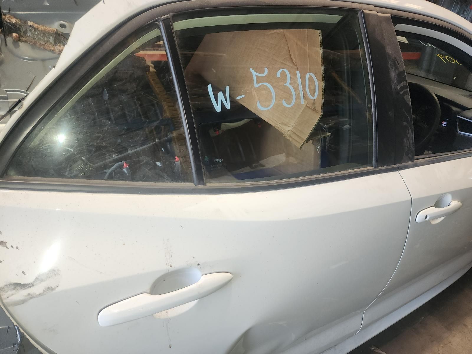 White Car With a Shattered Rear Side Window Marked “w 5310” — South West 4WD Wreckers In Harristown, QLD