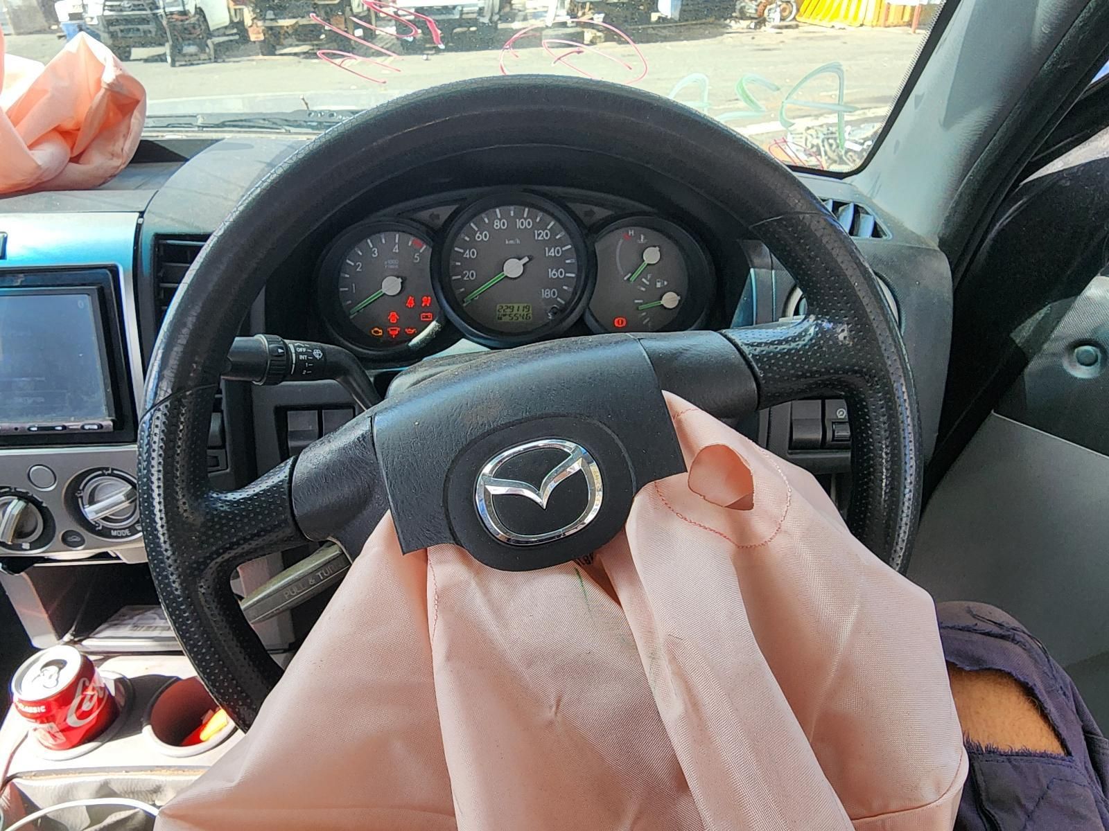 Driver’s View of a Mazda Steering Wheel and Dashboard — South West 4WD Wreckers In Harristown, QLD
