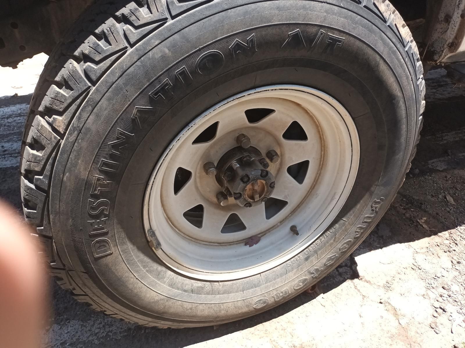 Flat Tire on A White Truck Wheel with A Damaged Rim and Worn Black Tyre — South West 4WD Wreckers In Harristown, QLD