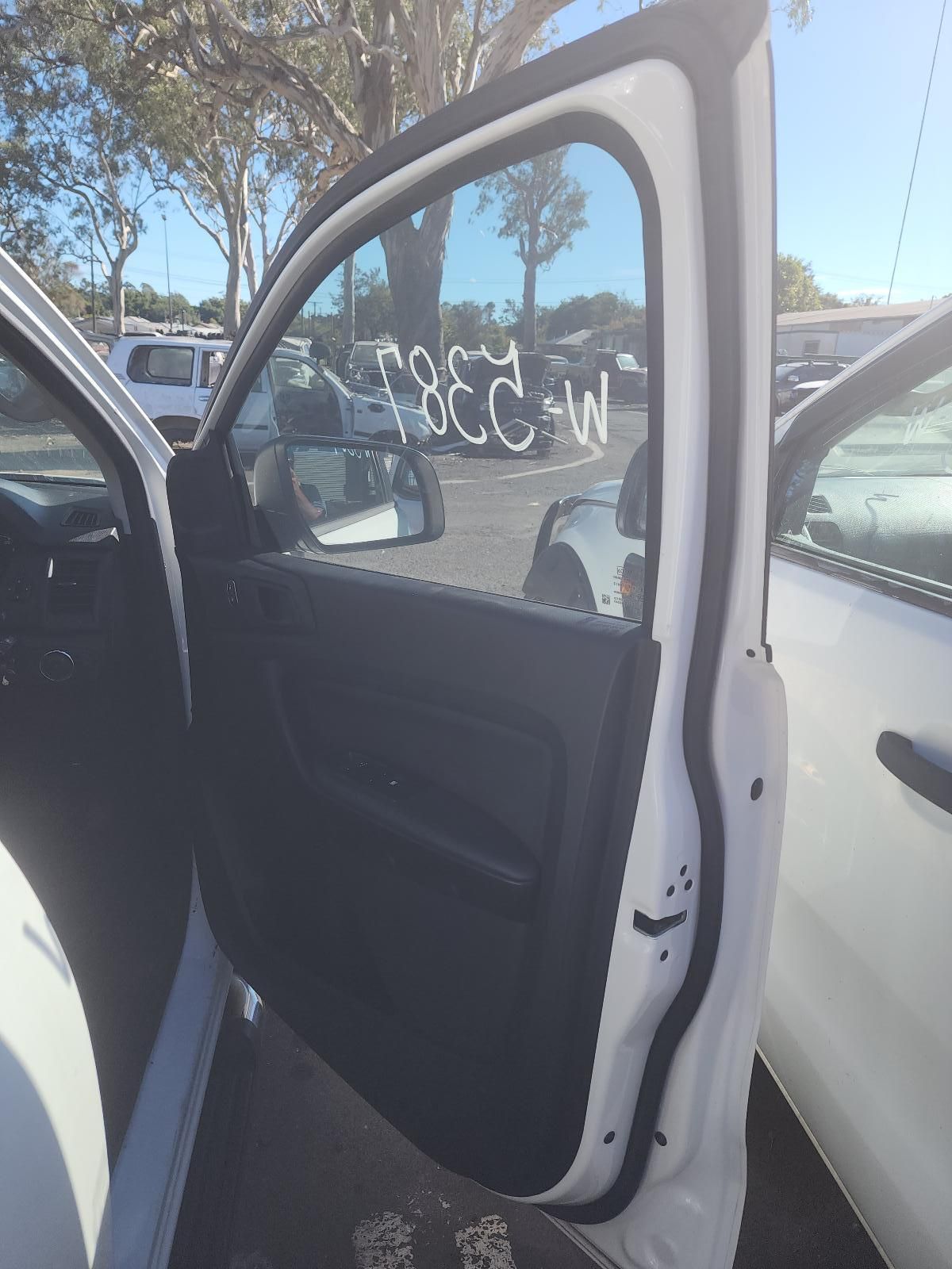 Open Car Door With Black Interior in a Parking Lot — South West 4WD Wreckers In Harristown, QLD