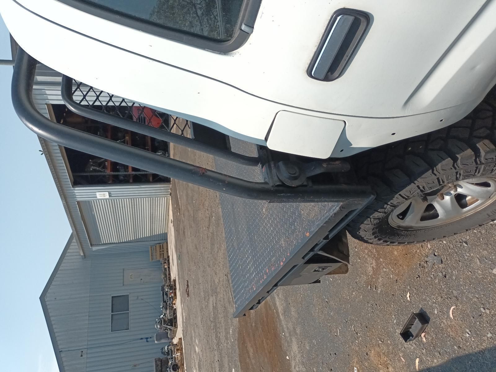 White Suv Parked Beside a Metal Ramp and Building Wall on A Gravel Lot — South West 4WD Wreckers In Harristown, QLD