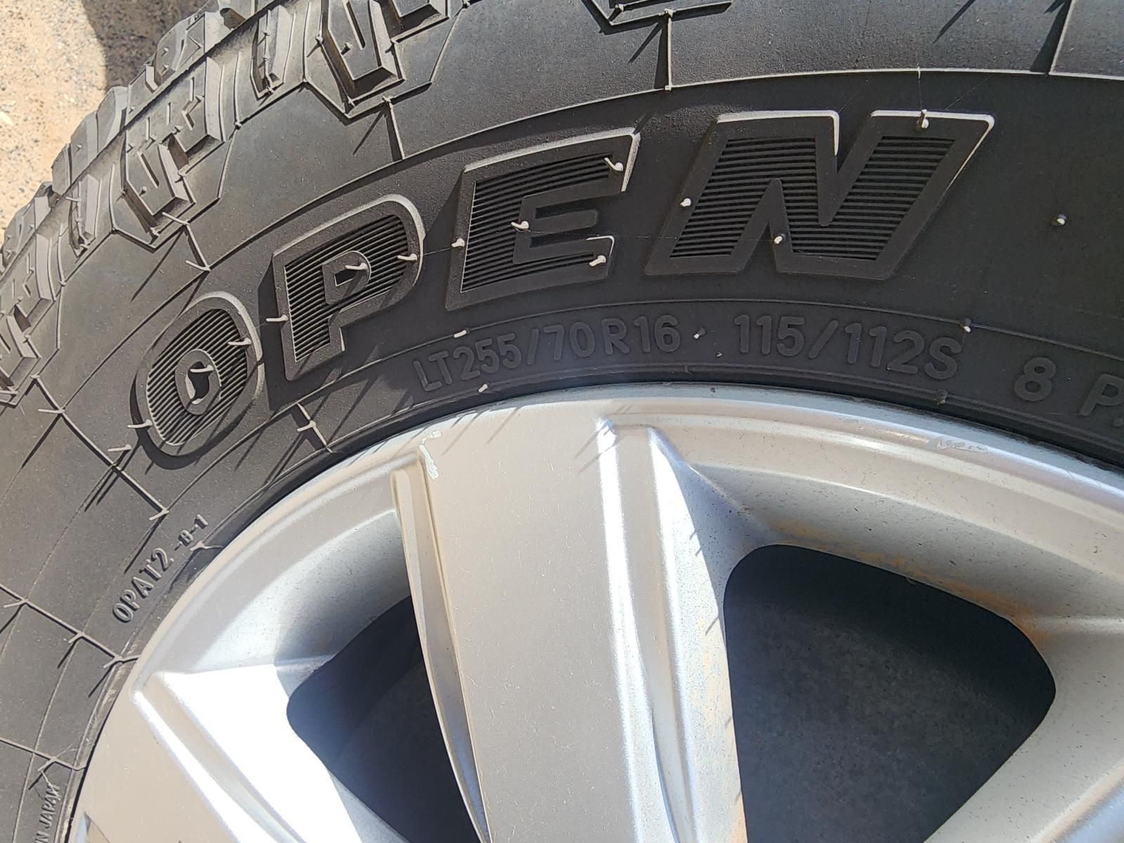 Close-up of a Car Tire With Raised “open” Lettering — South West 4WD Wreckers In Harristown, QLD