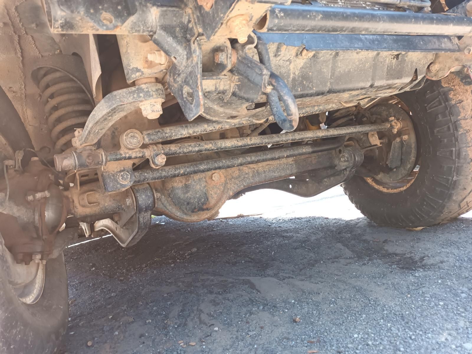 Undercarriage of A Muddy Off-Road Truck with Visible Suspension — South West 4WD Wreckers In Harristown, QLD