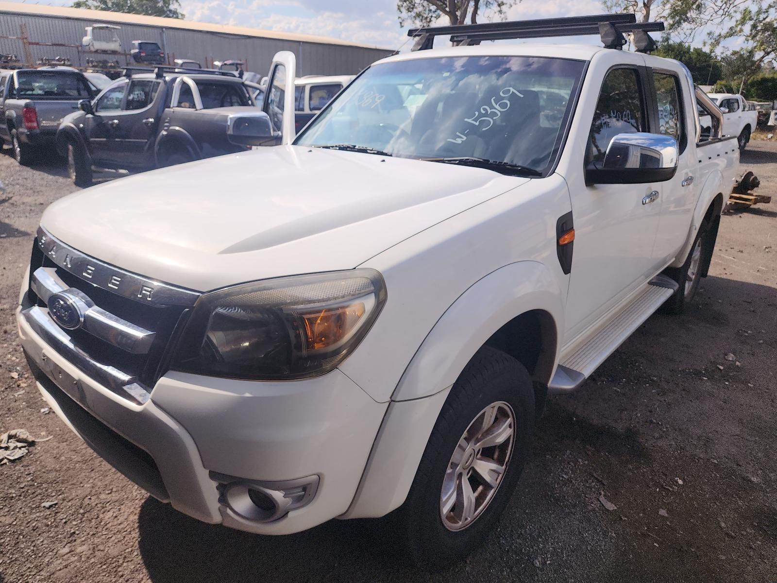 White Pickup Truck Parked in a Lot, Front-left View — South West 4WD Wreckers In Harristown, QLD