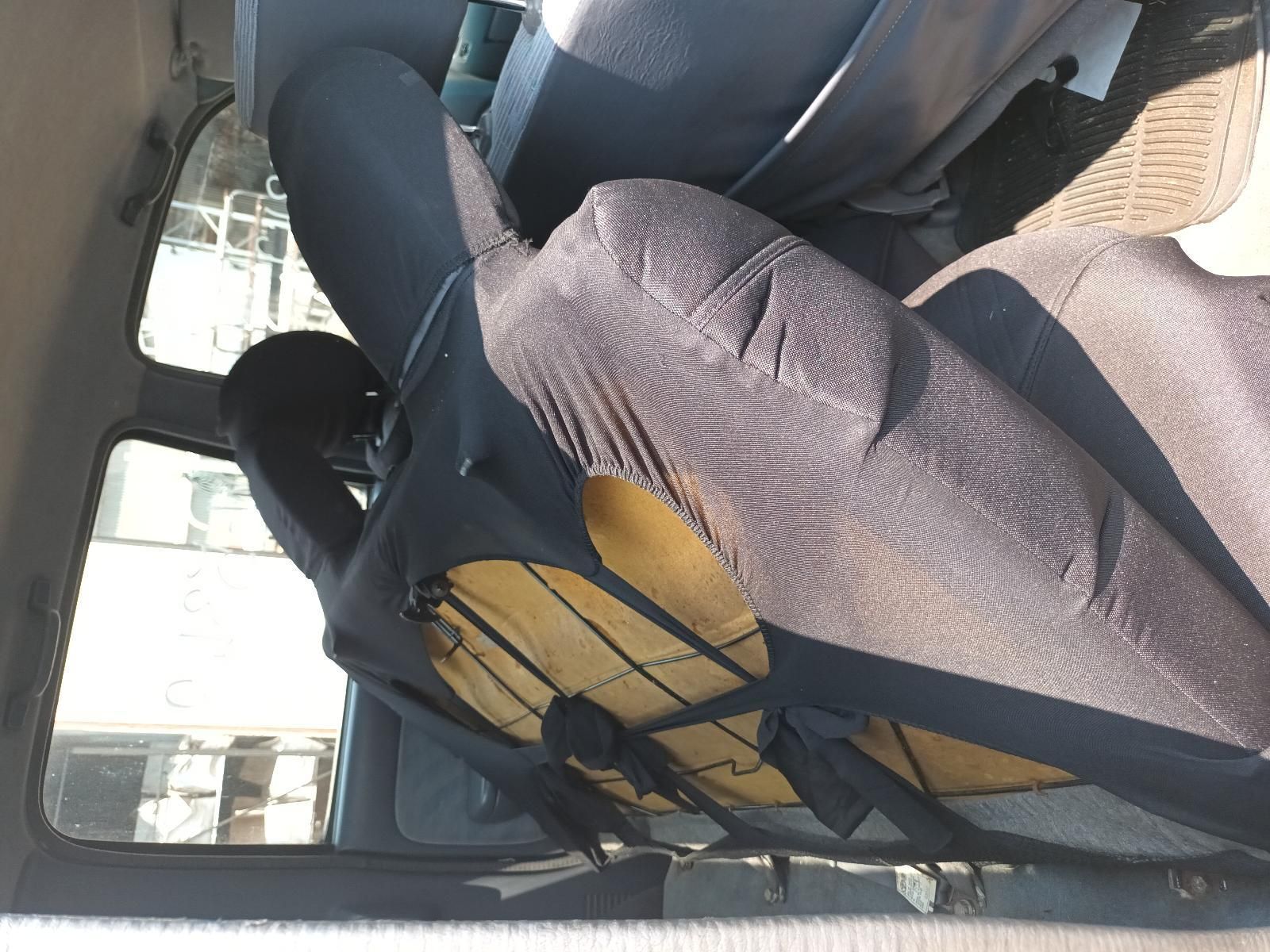 Two Seated People in A Car, One in A Black-And-Yellow Top — South West 4WD Wreckers In Harristown, QLD
