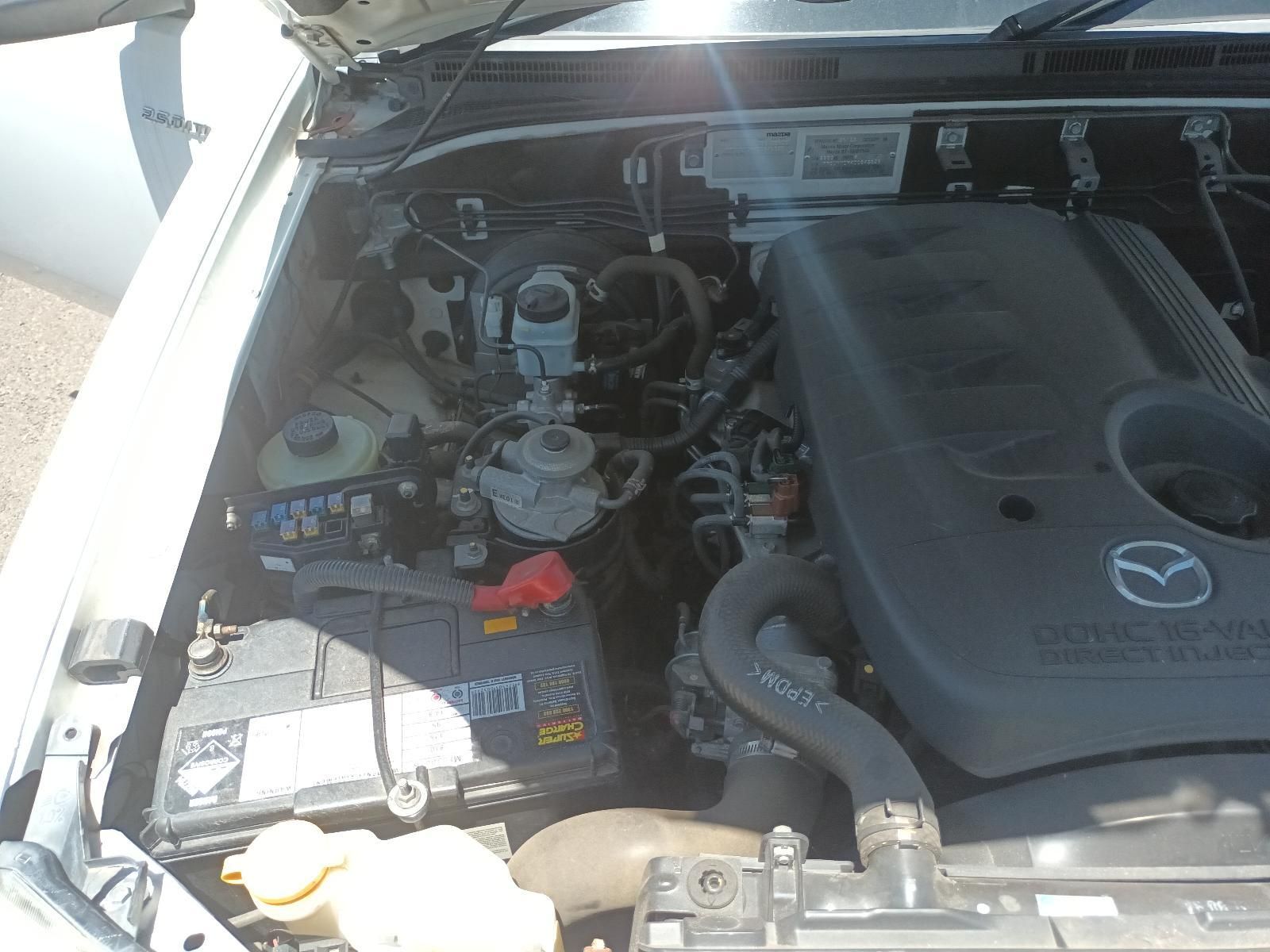 Open Car Hood Showing the Engine Bay and Mazda Engine Cover — South West 4WD Wreckers In Harristown, QLD